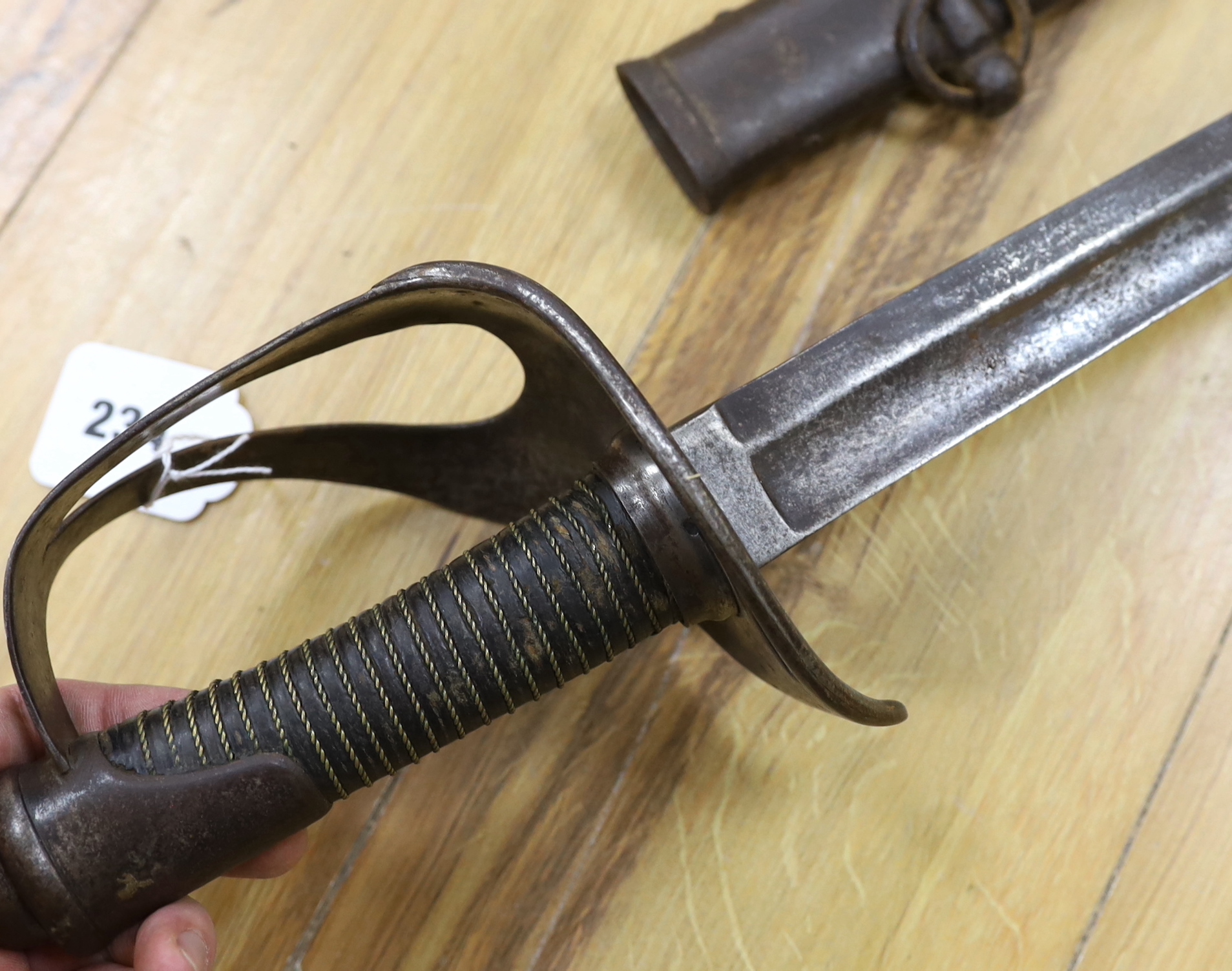A pair of late 19th century German swords, one in its scabbard, together with another unrelated scabbard, made for the international arms trade, probably in Solingen, blade 89cm. Condition - fair, scabbards are 87cm and